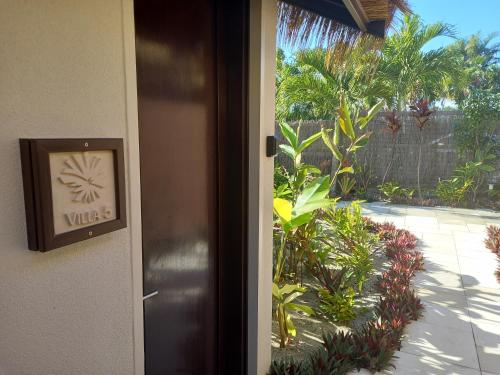an open door with a view of a garden at Serenity Villas Rarotonga in Rarotonga