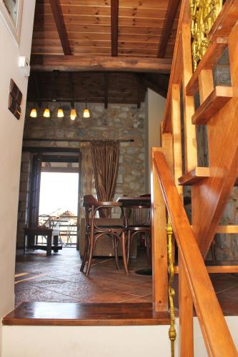 a dining room with a table and wooden stairs at Abelos Villas in Áyios Ioánnis
