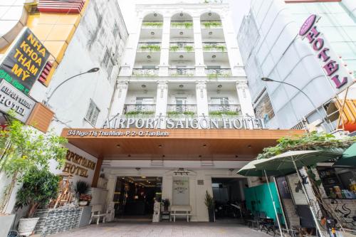 a building with a sign on the front of it at Airport Saigon Hotel - Gần ẩm thực đêm chợ Phạm Văn Hai in Ho Chi Minh City