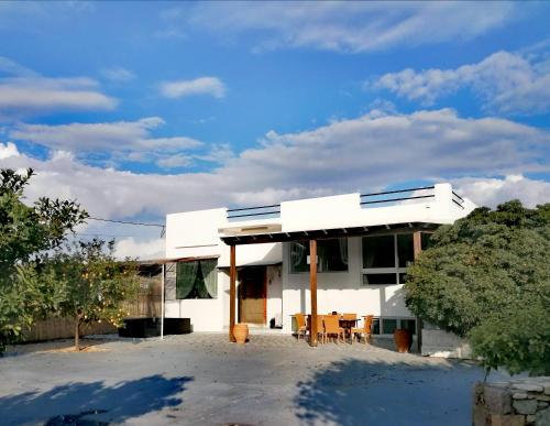 a white house with a blue sky in the background at Villa Sevasti in Kardamaina