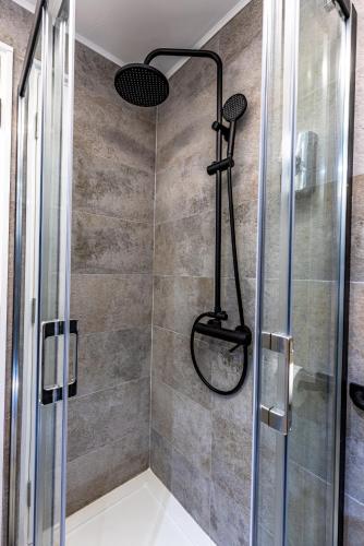 a bathroom with a shower with a glass door at no. 1 in Kulpin