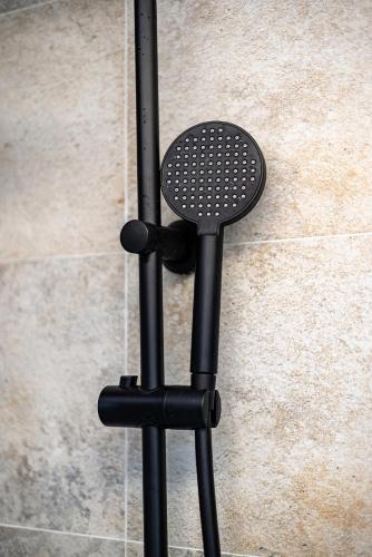 a black stand with a black microphone on a wall at no. 1 in Kulpin