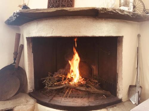a brick oven with a fire in it at KYTHIRA ISLAND RETREAT in Áyios Ilías