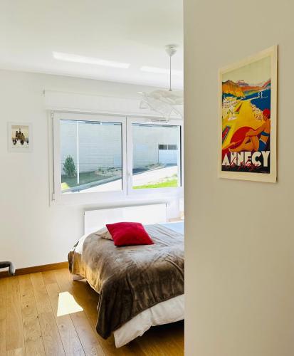 une chambre avec un lit et deux fenêtres dans l'établissement Lac arte postale, à Annecy