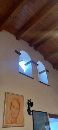 two lights hanging on a wall with a picture at B&B da Maria Teresa - Maratea in Maratea