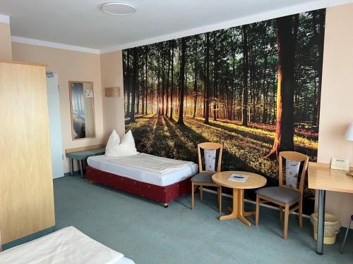 a hotel room with a bedroom with a forest mural at Hotel Thannhof in Schweitenkirchen