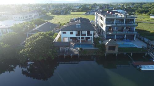 an aerial view of a house and a large body of water at Gardenia Apartment-04 in Nadi