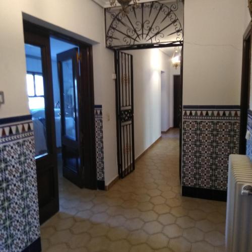 a hallway with two doors and a tile floor at Taragudo in Laguna de Duero