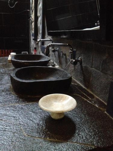 a group of three sinks in a bathroom at Valhalla Boutique Hotel in Salatiga