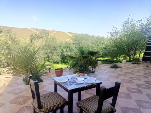 a table and two chairs on a patio at Farmer stay hostel in Wadi Musa