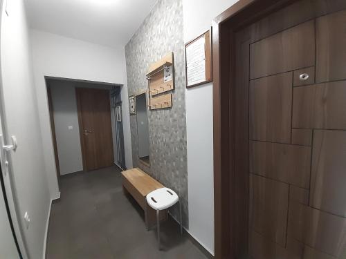 a bathroom with a toilet and a wooden door at Lefterov's Guests Suite in Varna City
