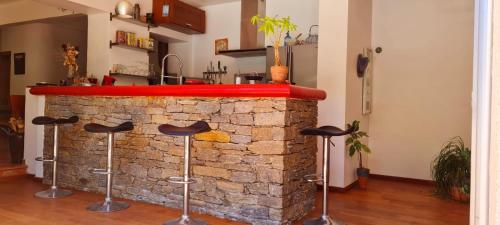 a brick fireplace with stools in front of it at Coeur de ville maison piscine in Saint-Raphaël