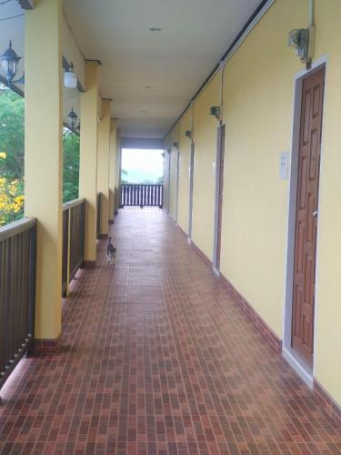an empty hallway with a cat sitting on the floor at Chatchawan Resort in Ban Tha Sao