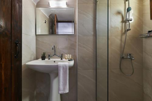 a bathroom with a sink and a shower at Mila Malia Studios Hotel in Malia