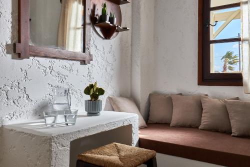 a living room with a couch and a table at Mila Malia Studios Hotel in Malia