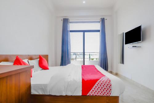 a bedroom with a bed and a large window at Collection O All Season in Udaipur