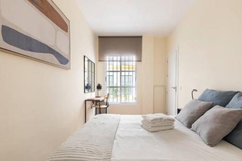 um quarto com uma cama branca e uma janela em Azahar Metropol Parasol, Medium-sized Parking gifted for free em Sevilha