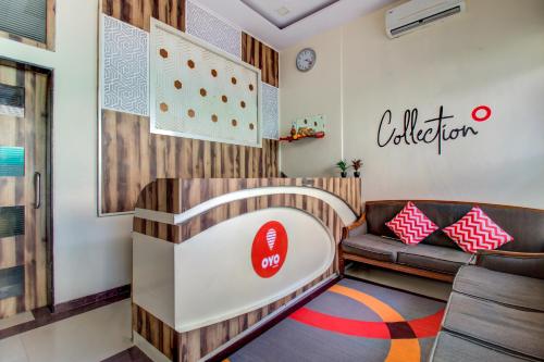 a childrens waiting room with a couch and a chair at Golden Tulipz Boutique in Mumbai