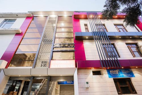a facade of a building with colorful at Collection O Sapphire in Manī Mājra