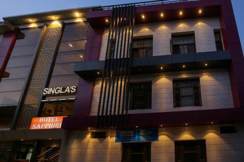 a building with a sign on the side of it at Collection O Sapphire in Manī Mājra