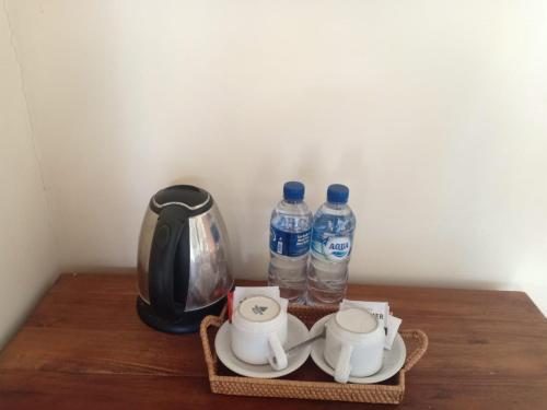 two bottles of water sitting on top of a table at Intan Villa & Suite Ubud in Ubud