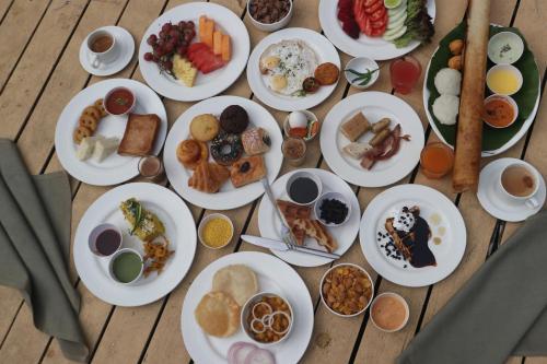 a table full of plates of food on a table at Crowne Plaza Pune City Centre by IHG in Pune