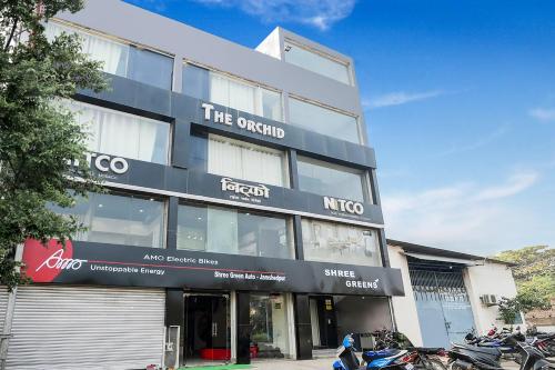a building with motorcycles parked in front of it at Super Hotel O The Orchid in Jamshedpur