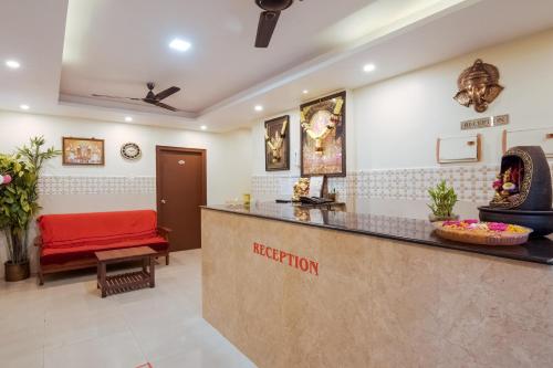 a waiting room at a hospital with a red bench at Hotel O Anu Grand in Visakhapatnam