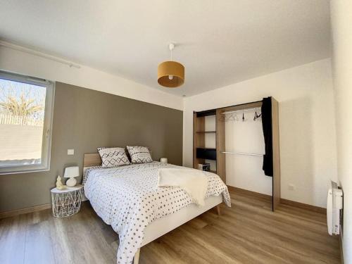 um quarto com uma cama grande e uma janela em Appartement 4 au calme dans le Sauternais em Budos