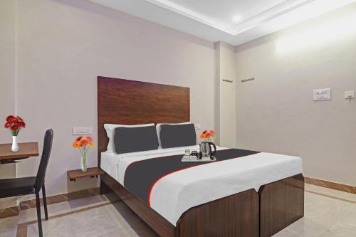 a bedroom with a large bed with a wooden headboard at Srinika Inn in Hyderabad
