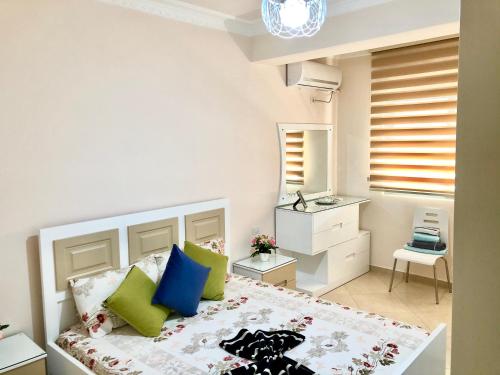 a small bedroom with a bed and a bathroom at Queen Isabella Premium in Vlorë