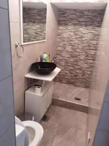 a bathroom with a sink and a toilet and a shower at VMJ Apartements in Agia Triada