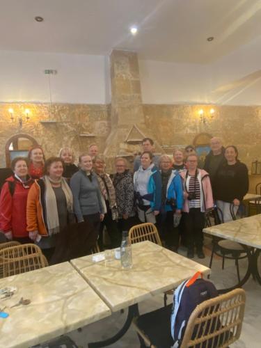 a group of people standing in a room with tables at Costas Inn in Spílion