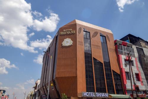 a building with a clock on the side of it at Treebo Trend Shivani in Indore