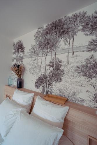 a bedroom with a mural of trees on the wall at Les clés d'à côté - maison d'hôtes de charme près de Rouen in Sotteville-lès-Rouen