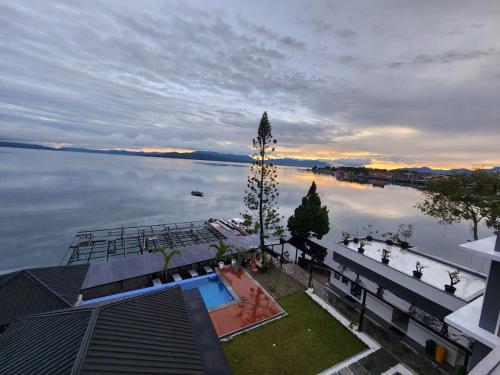 an aerial view of a house on the water at PURNAMA BALIGE HOTEL in Balige