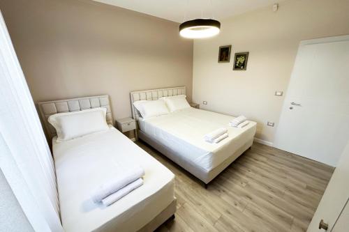 a room with two beds and a mirror at Nicolaus Hidden Gem Villa in Shkodër