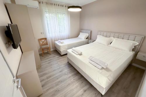 a small room with a bed and a tv at Nicolaus Hidden Gem Villa in Shkodër