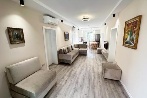 a living room with two couches and a couch and a living room at Nicolaus Hidden Gem Villa in Shkodër