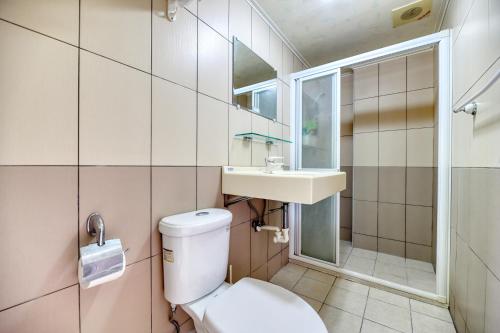 a bathroom with a toilet and a sink at Chunfa B&B in Huxi