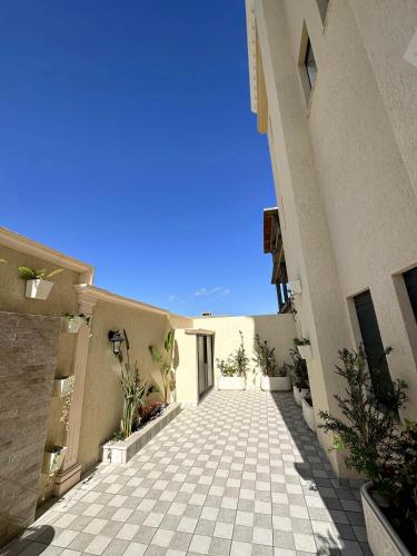 a walkway between two buildings with a blue sky at Luxury 3 Bedrooms Apartment Sea View in Rejiche