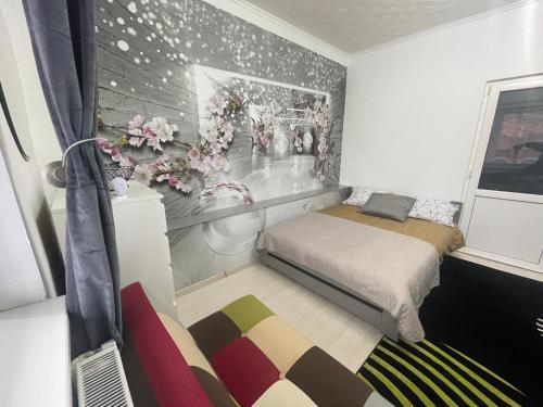 a small bedroom with two beds and a window at CENTRAL Colors Studio Petrosani in Petroşani