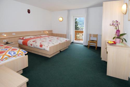 Postel nebo postele na pokoji v ubytování Hotel Zanon