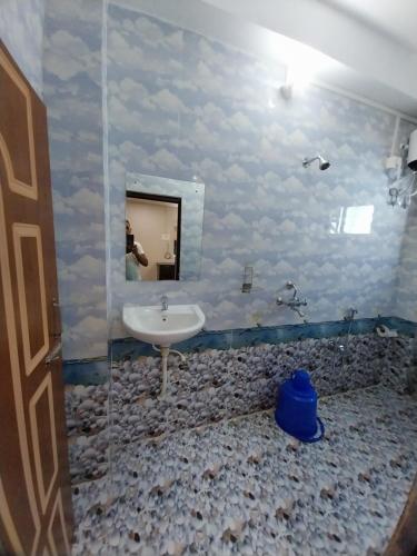 a bathroom with a sink and a mirror at Le Luminous, Home Stay in Port Blair