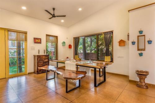 a bathroom with two sinks and a table at SaffronStays Beach Blues, Alibaug in Alibaug