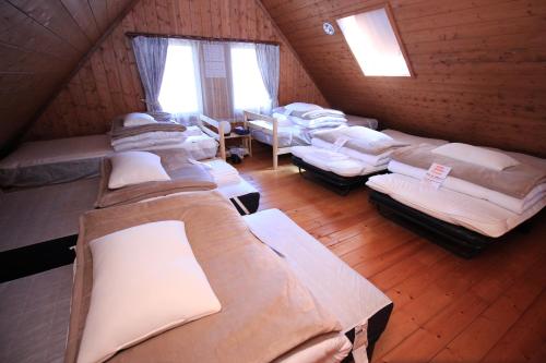 a room with a bunch of beds in a cabin at Log village FIKA / Nasu / Woodstove / Starry sky in Nasu
