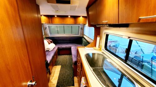 a small room with a couch and a sink in it at Que Camper Ct Full Bath in New Haven