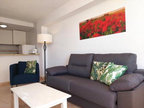 a living room with a couch and a table at Best View - Welcome Penthouse Apartamentos Karola in Benidorm