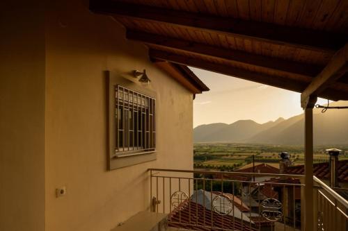 a balcony of a house with a view of a valley at Σπίτι με Τζάκι & Θέα in Mesinón