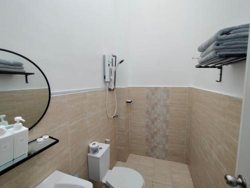 a bathroom with a shower and a toilet at Homestay 88A Melaka for 9 pax with Smart TV and Netflix and wifi in Melaka